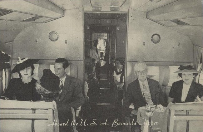 1930s The passenger cabin of a Pan Am Sikorsky S-42 flying boat.  Note the flight steward in the aisle.